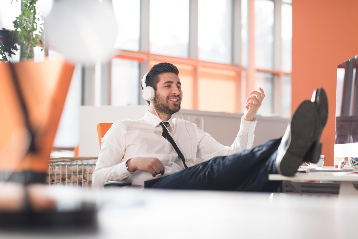 relaxed young business man at office photo