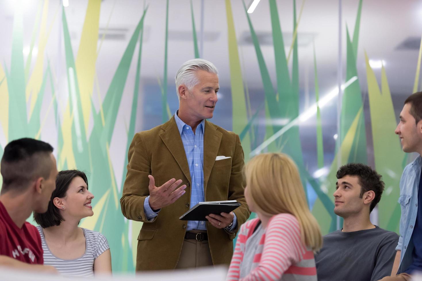 teacher with a group of students in classroom photo