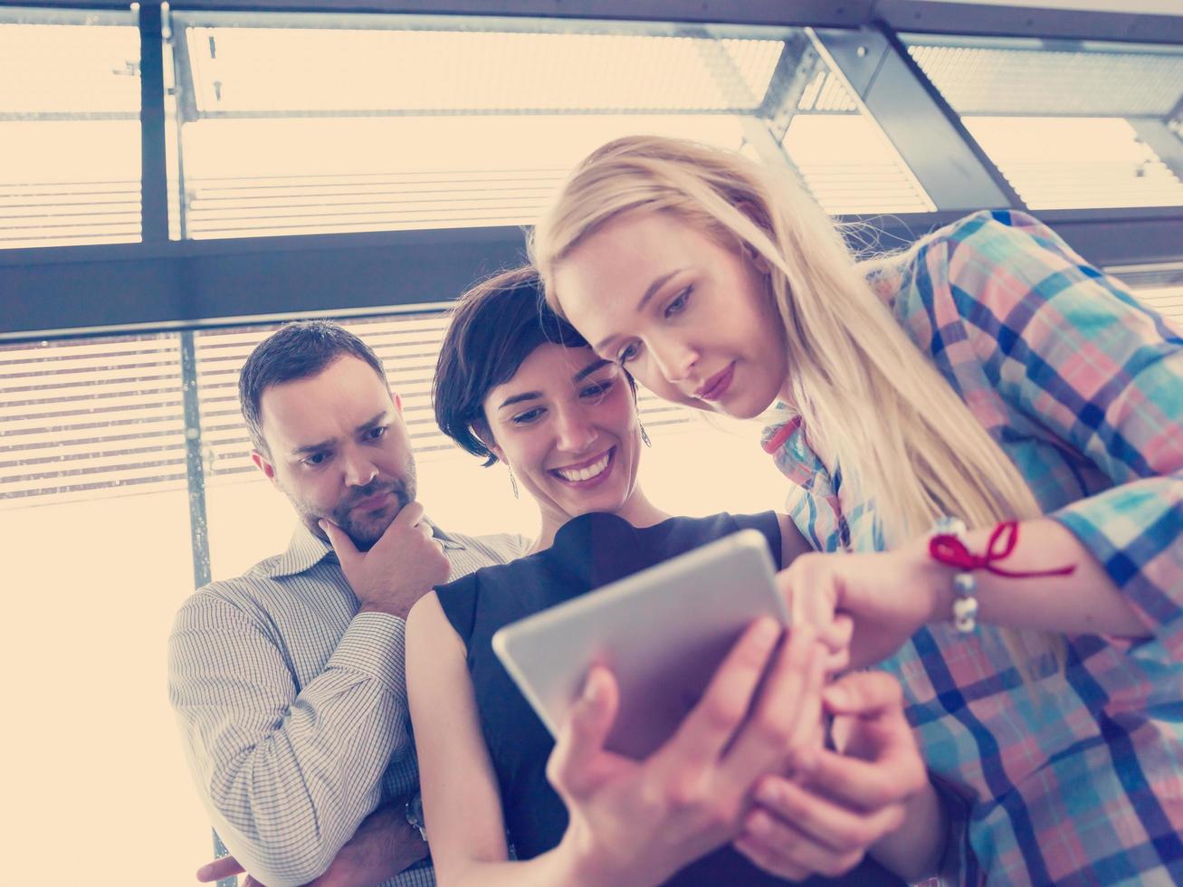 group of Business People Working With Tablet in startup office photo