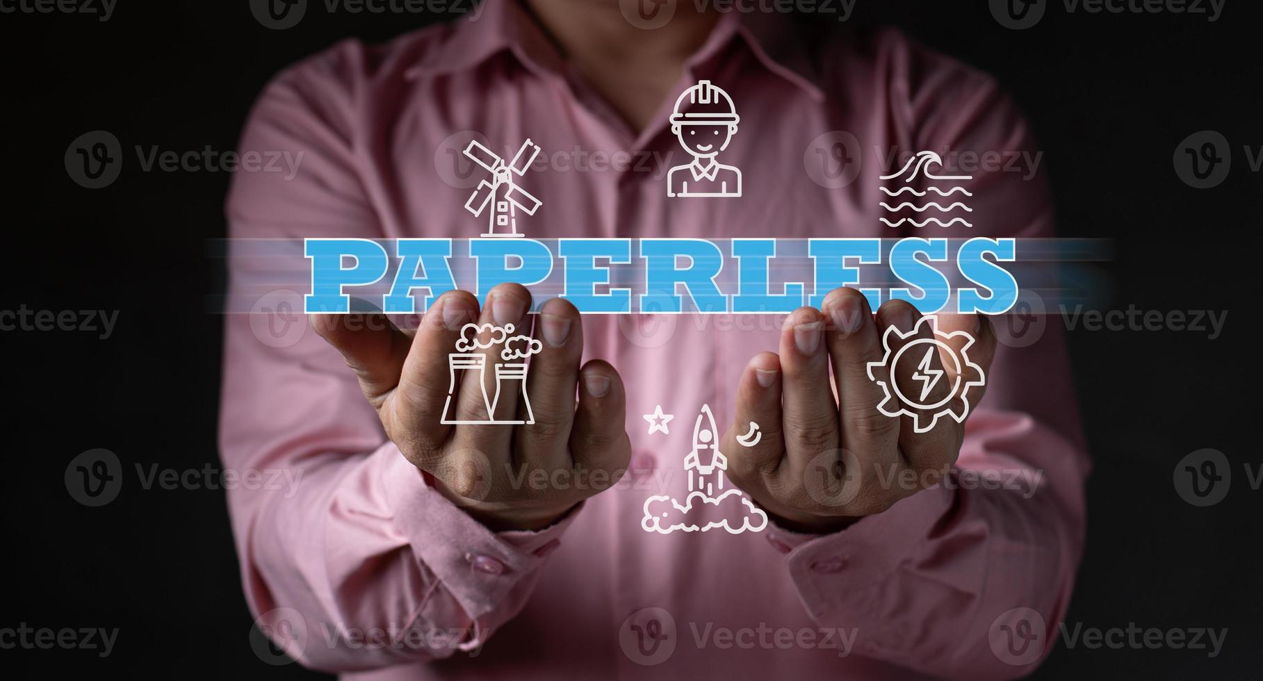A businessman holding paperless word, around by save environment icon, office and printing concept, company safe cost related, new digital file saving photo
