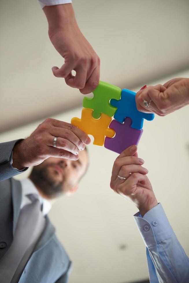 business people group assembling jigsaw puzzle photo