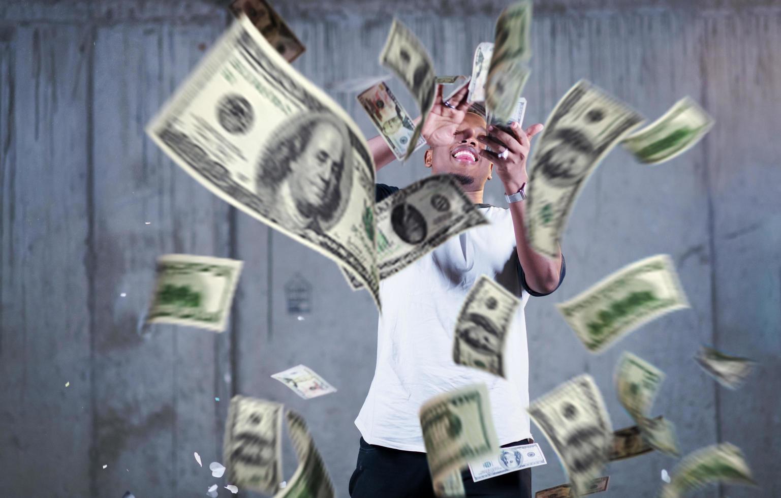 black businessman making the rain of money photo