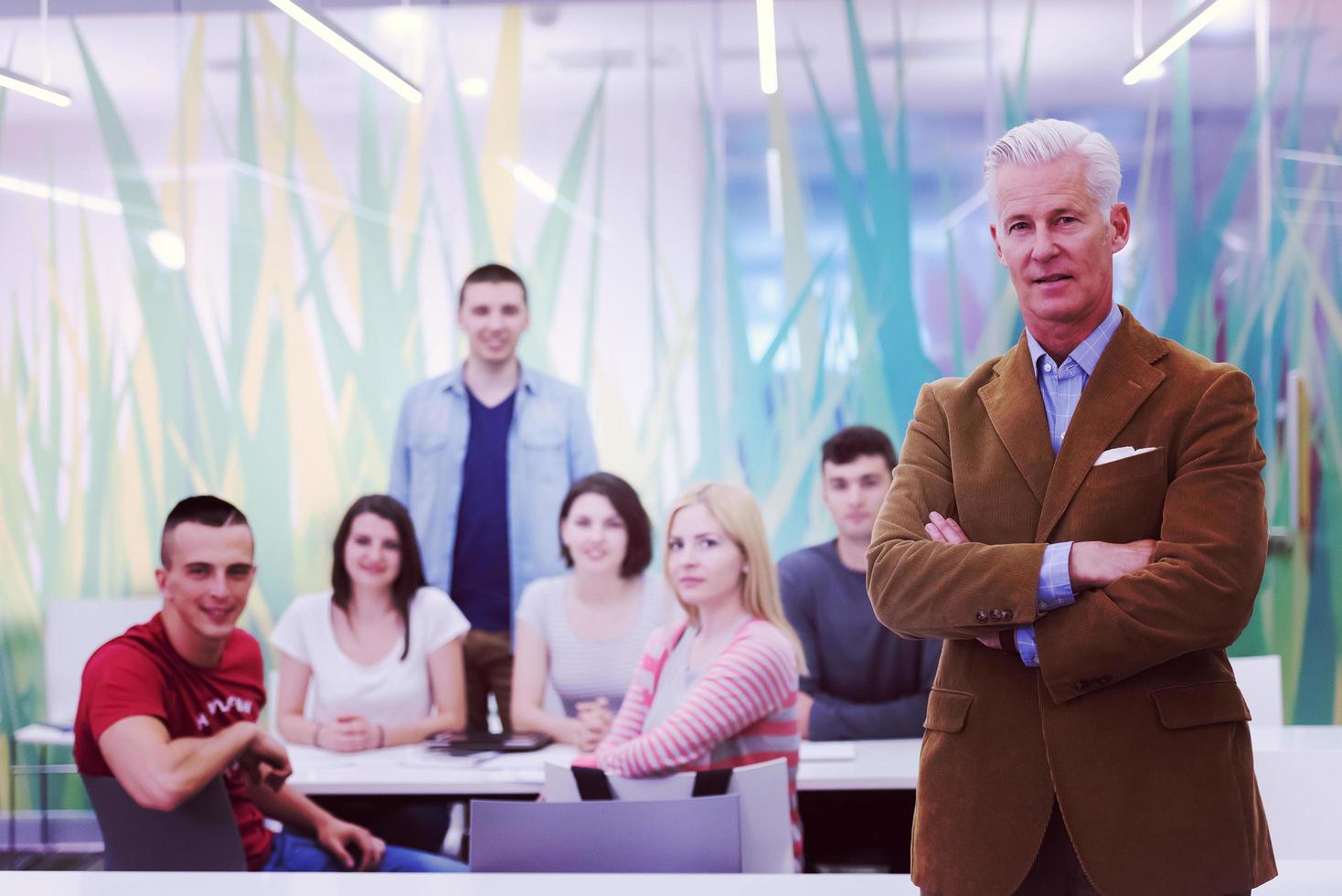 portrait of  teacher with students group in background photo