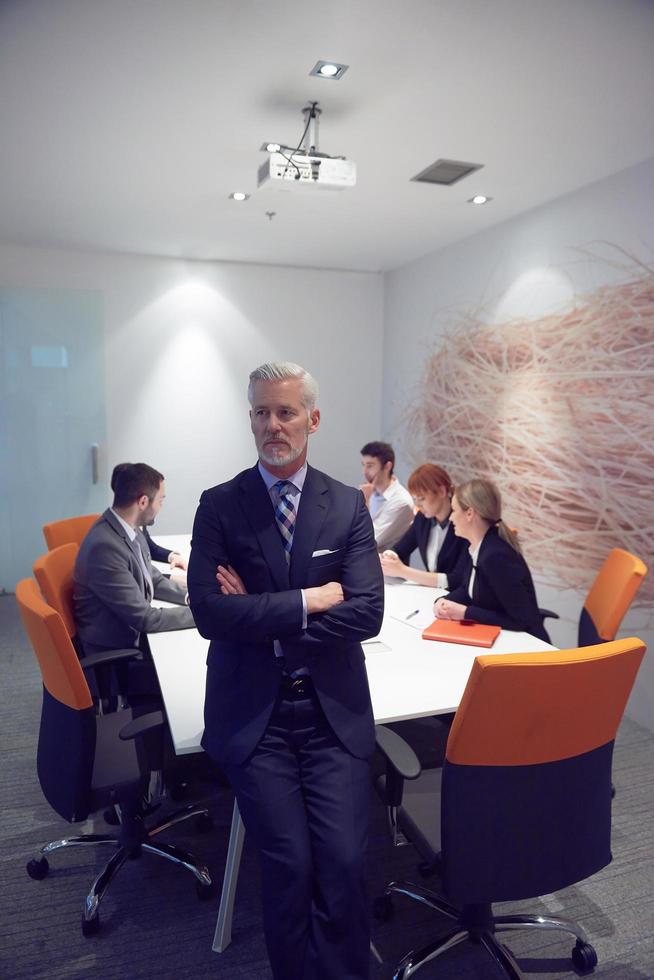 senior business man with his team at office photo