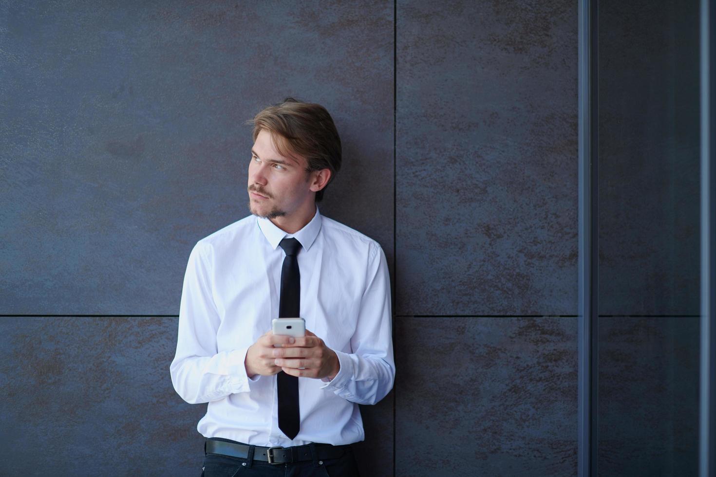 startup businessman in a white shirt with a tie using mobile phone photo
