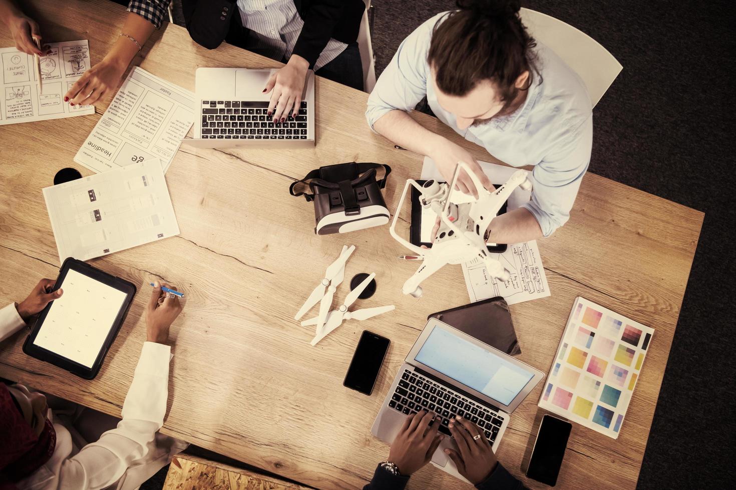 top view of multiethnic business team learning about drone technology photo