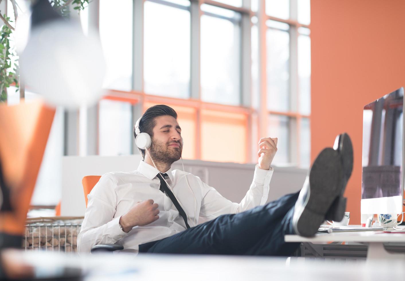 relaxed young business man at office photo