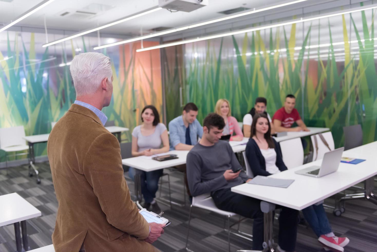 teacher with a group of students in classroom photo