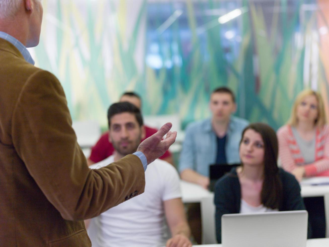 close up of teacher hand while teaching and explaining  lessons to studenst  in classroom photo