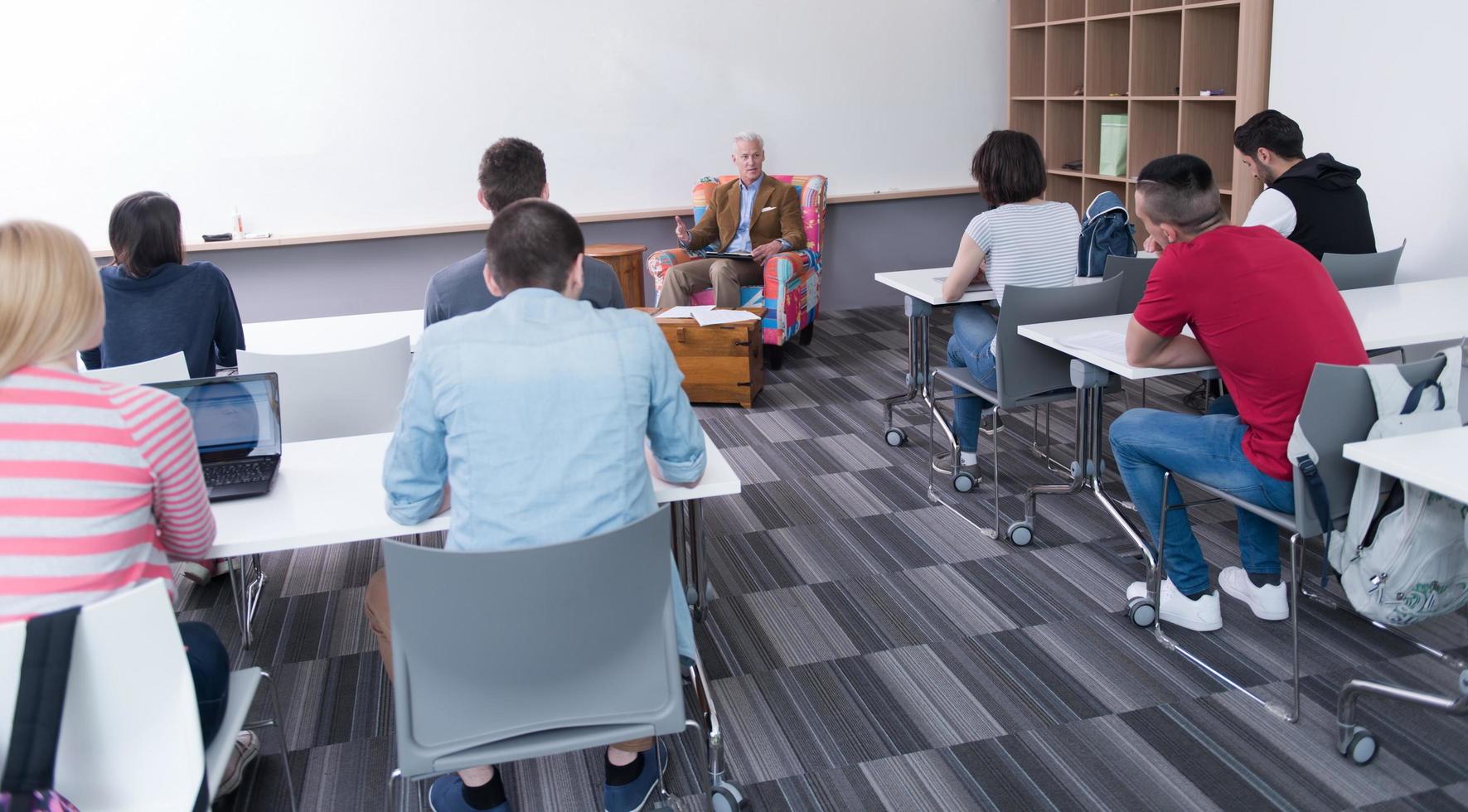 teacher with a group of students in classroom photo