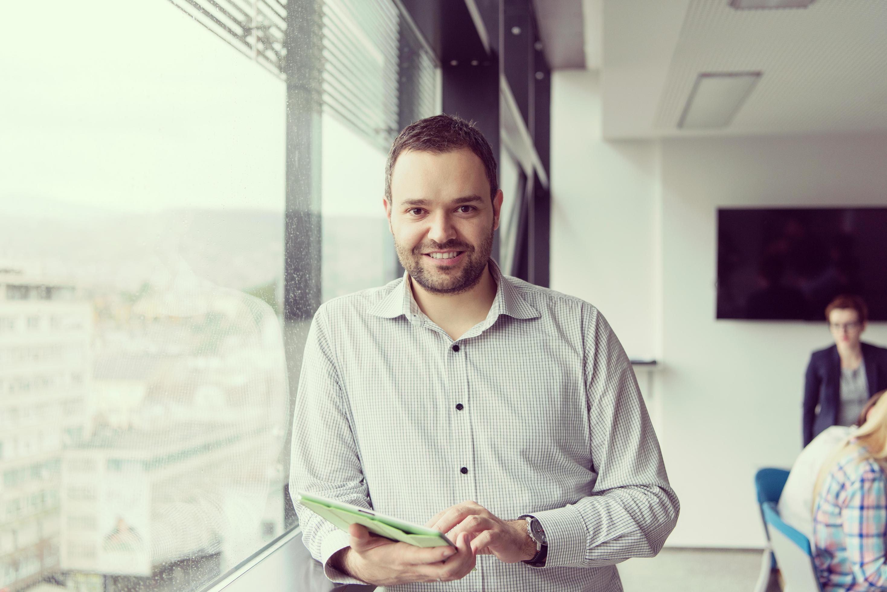 Businessman Using Tablet In Office Building by window 12440615 Stock