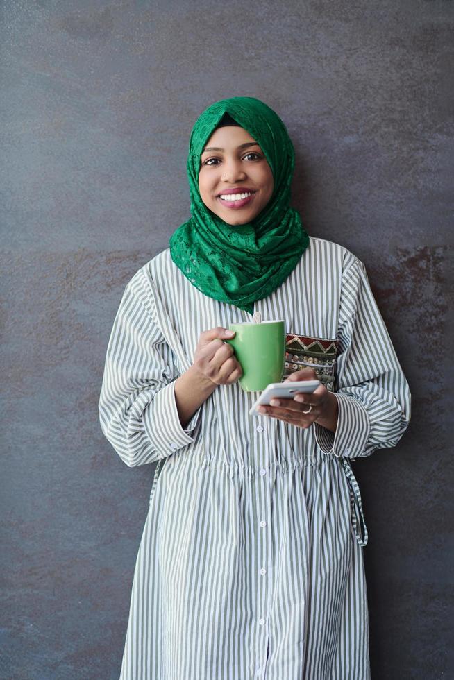 african muslim businesswoman with green hijab using mobile phone photo