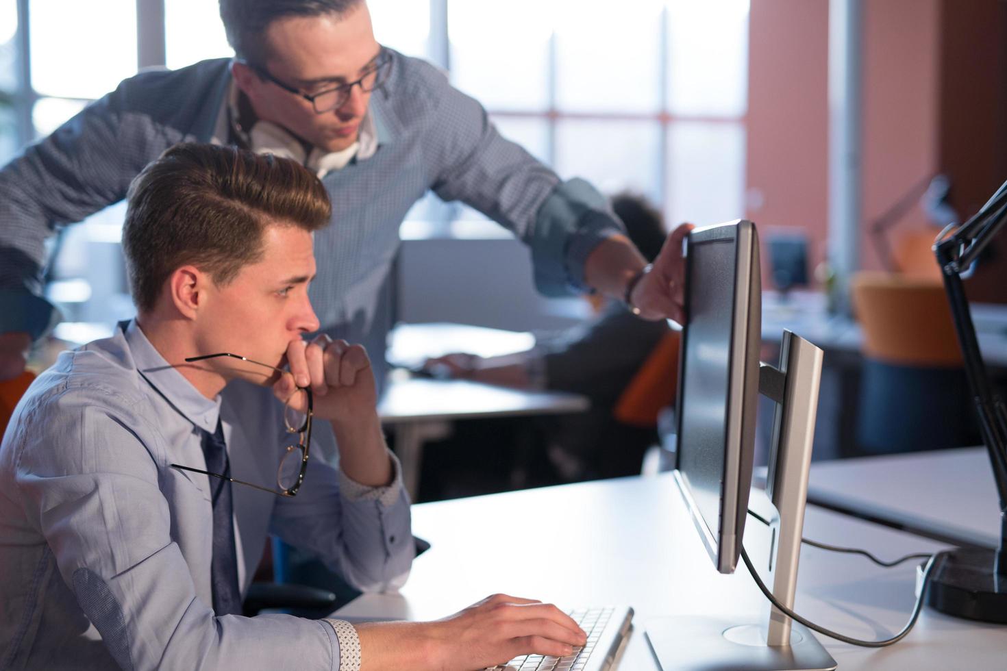 Two Business People Working With computer in office photo