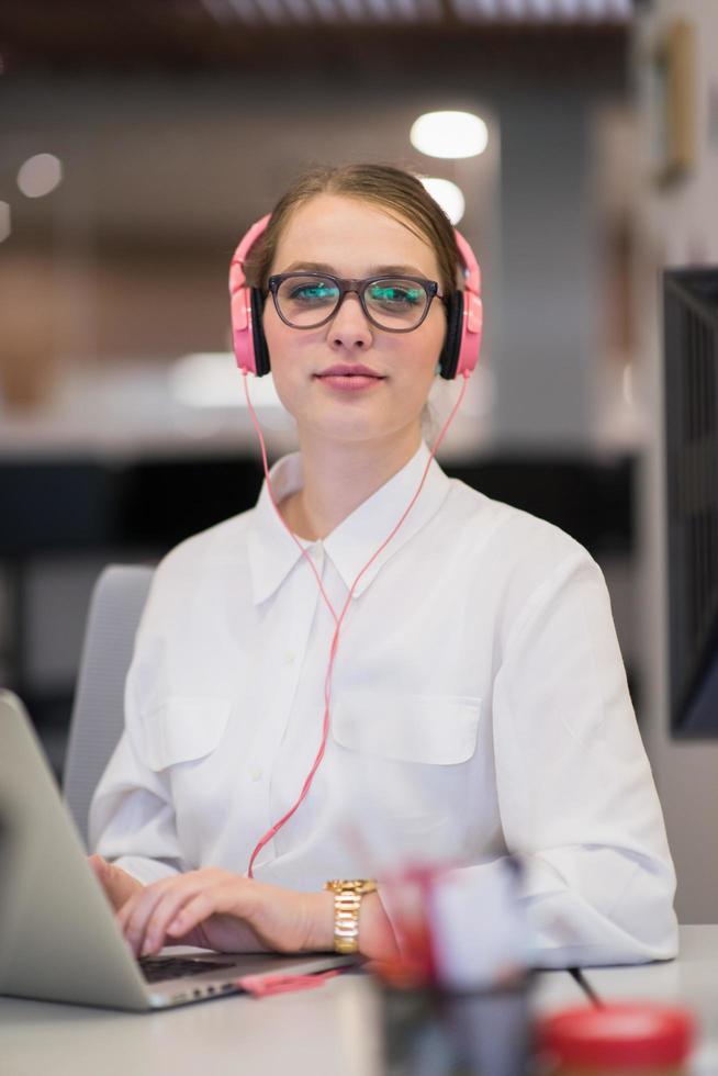 businesswoman using a laptop in startup office photo