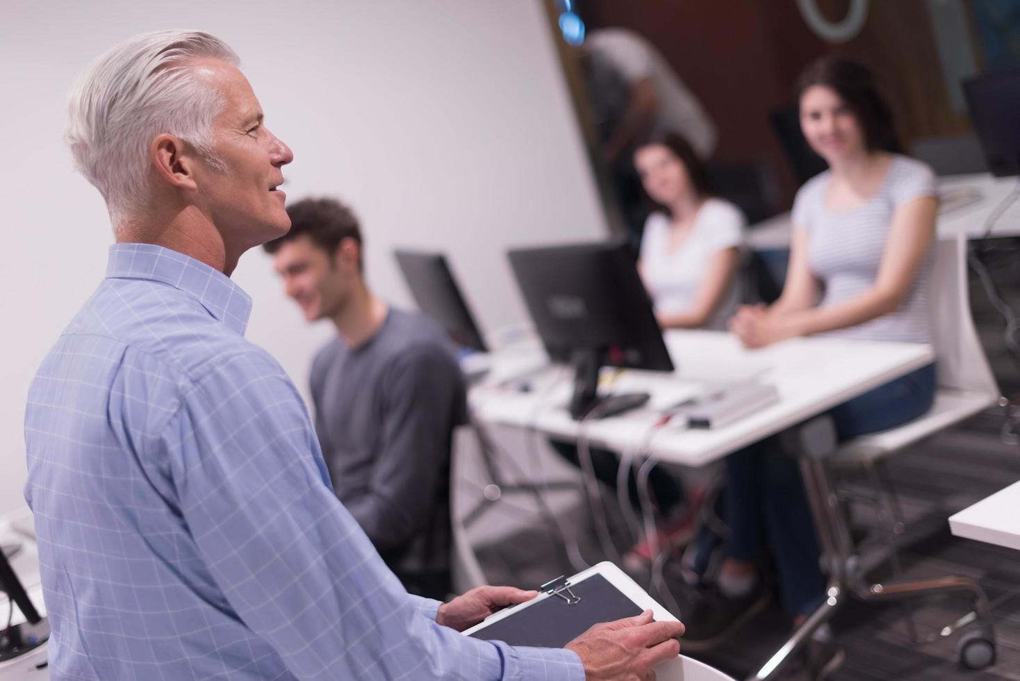 teacher and students in computer lab classroom photo