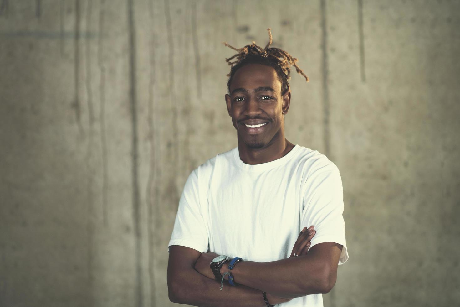 portrait of black businessman in front of a concrete wall photo