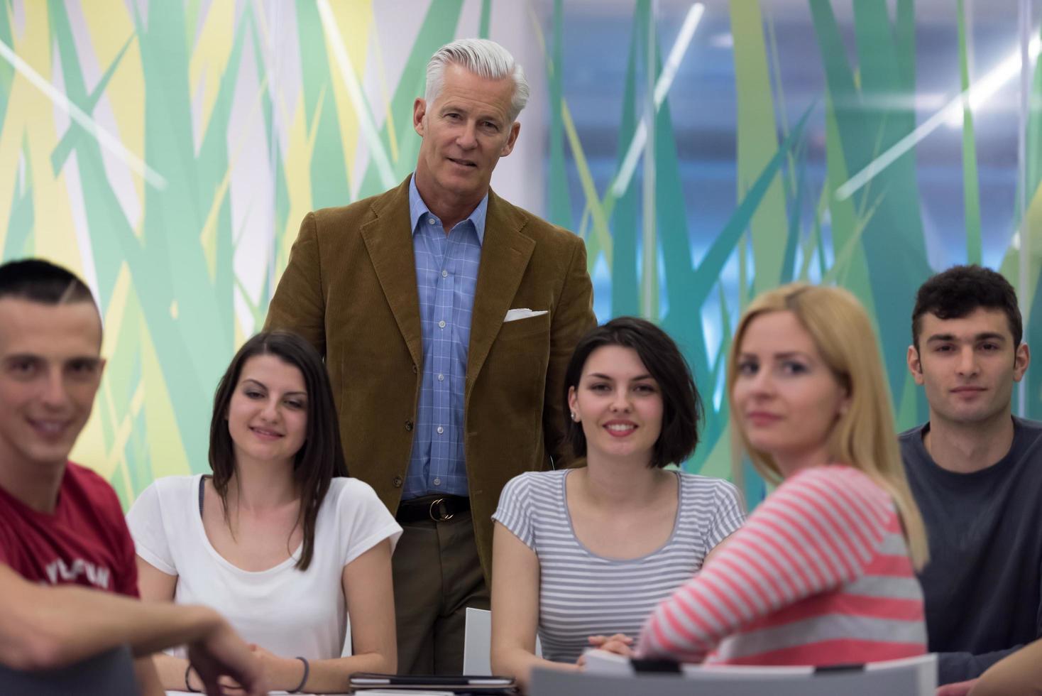 portrait of  teacher with students group in background photo