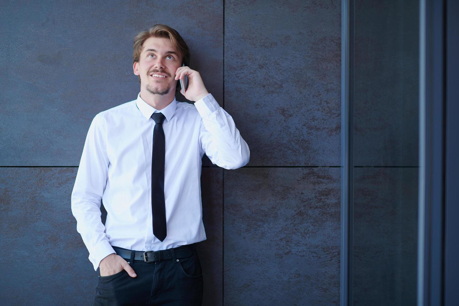 startup businessman in a white shirt with a tie using mobile phone photo