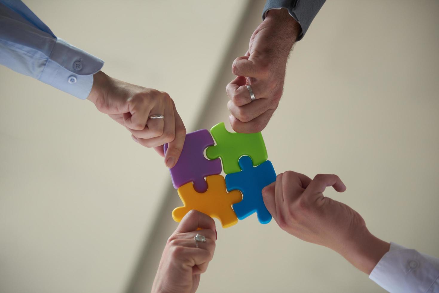 business people group assembling jigsaw puzzle photo