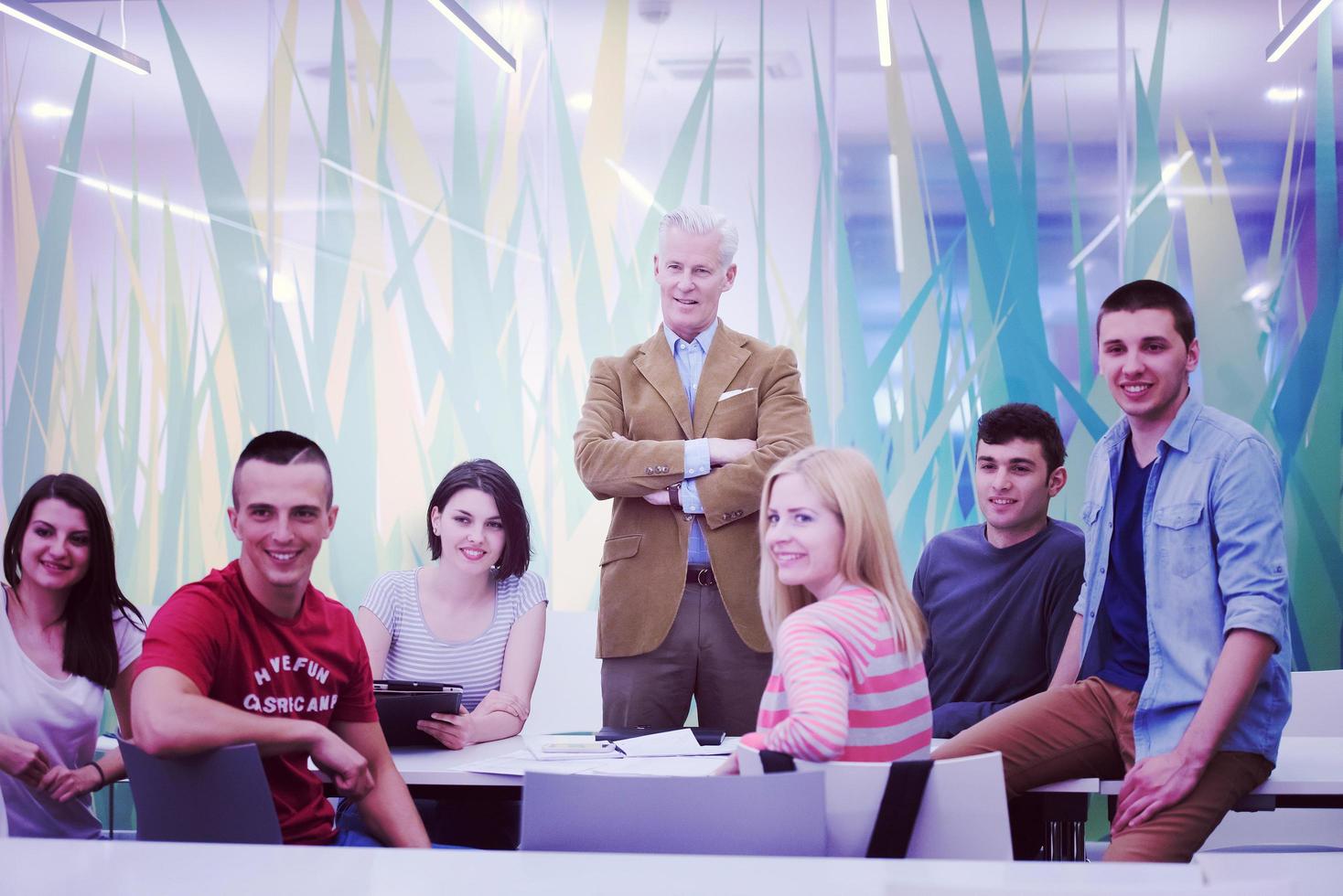 portrait of  teacher with students group in background photo