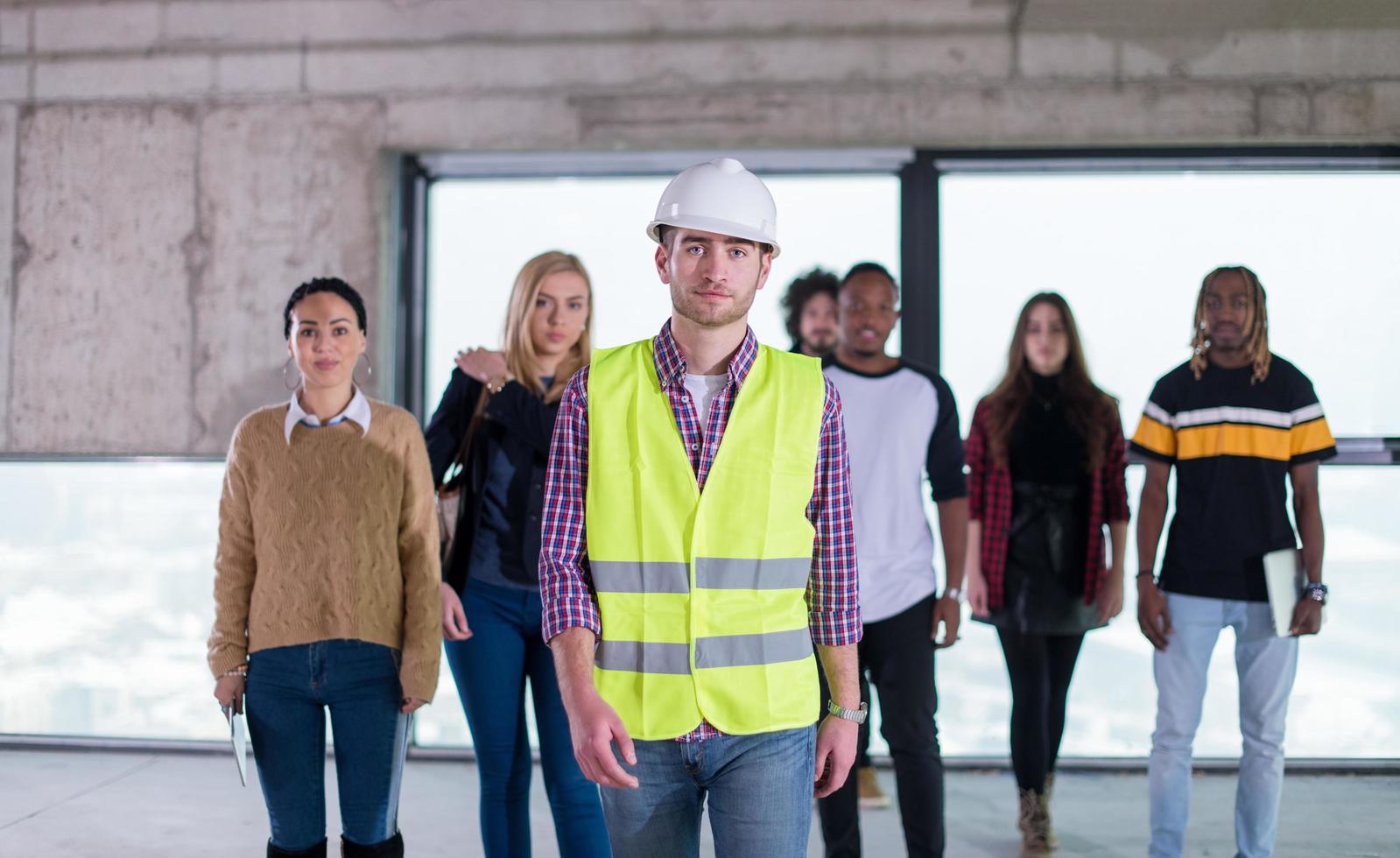 young multiethnic business people walking through unfinished startup office photo