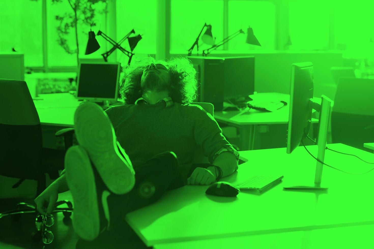 businessman sitting with legs on desk photo