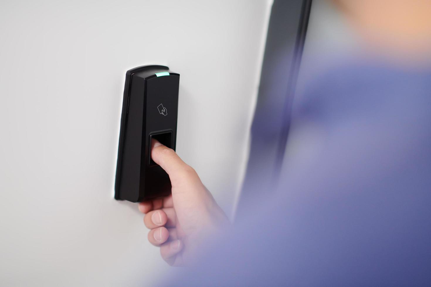 man pressing fingerprint scanner photo