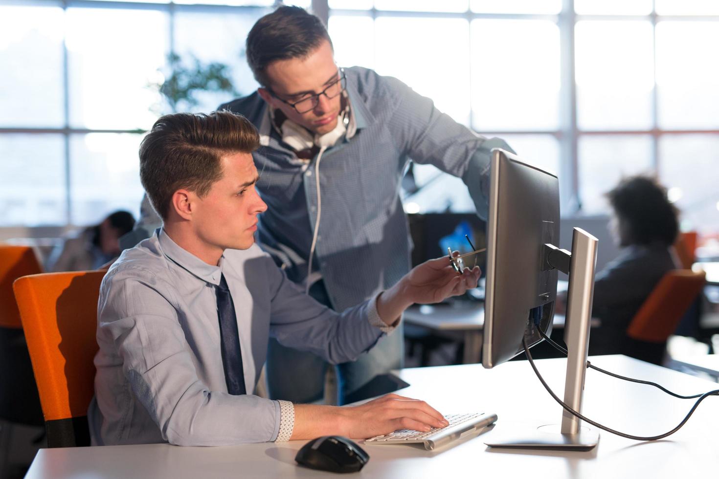 Two Business People Working With computer in office photo