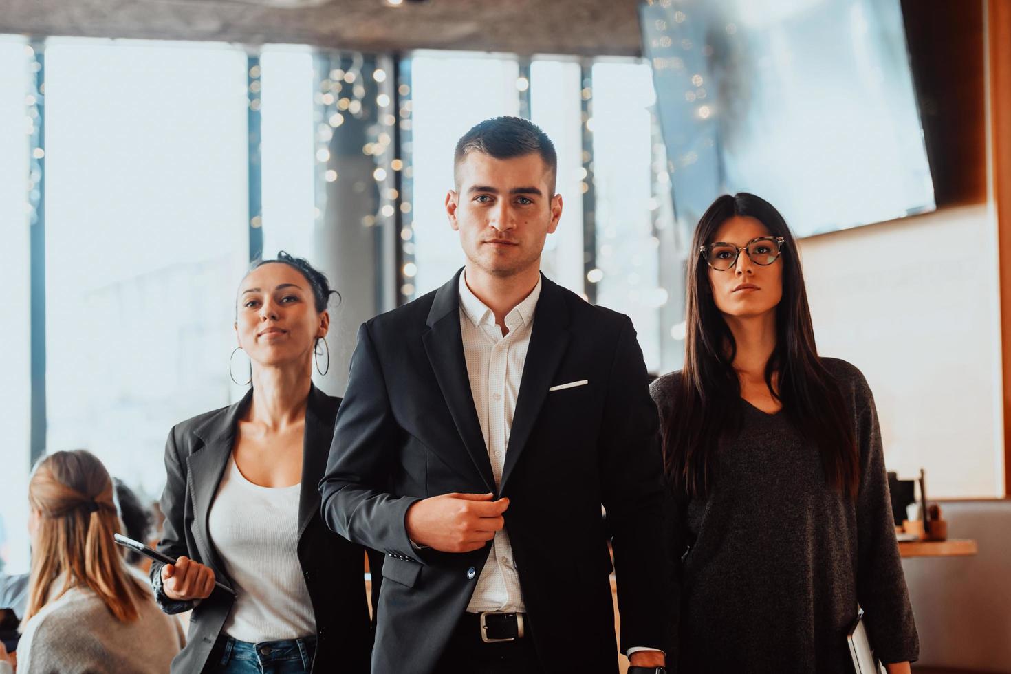 Group of successful business people standing together at modern coworking office. photo