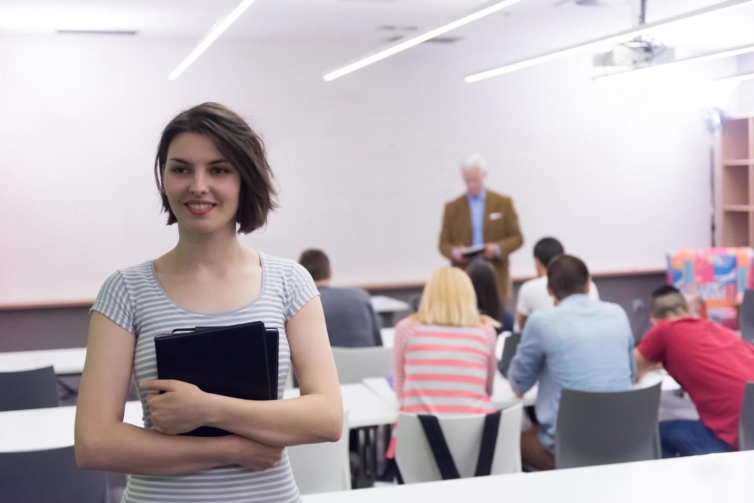 portrait of happy female student in classroom photo