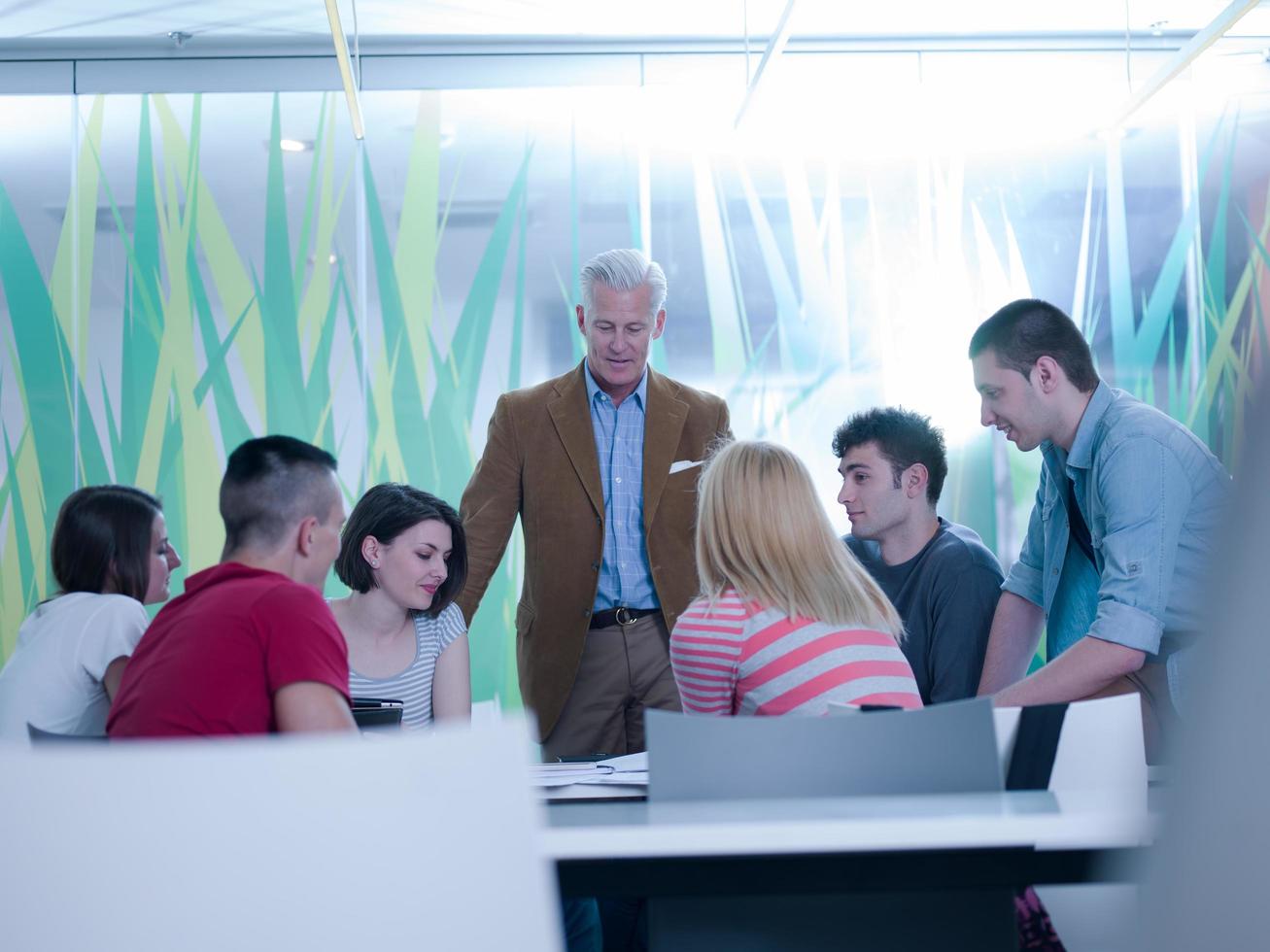 teacher with a group of students in classroom photo