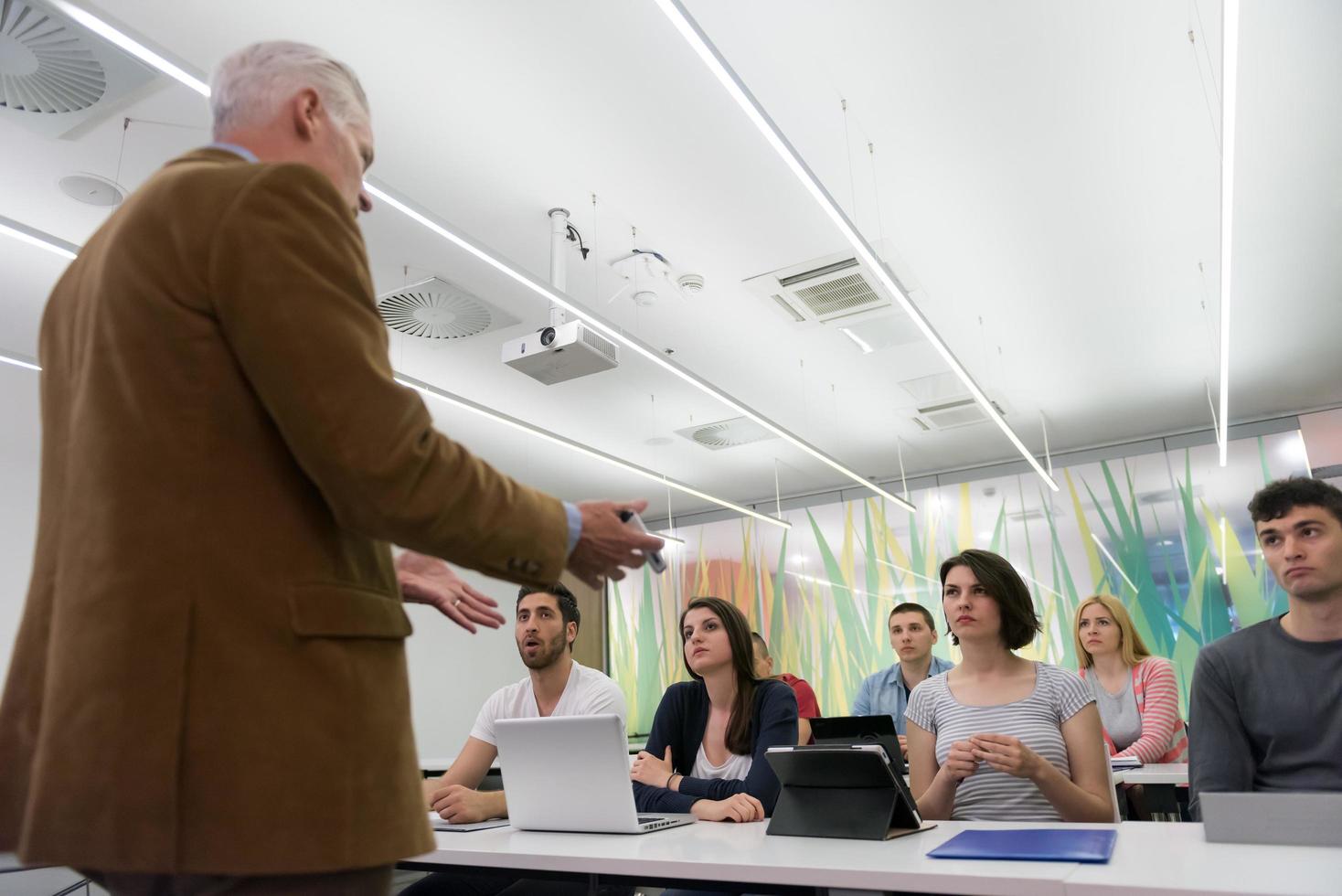 teacher with a group of students in classroom photo