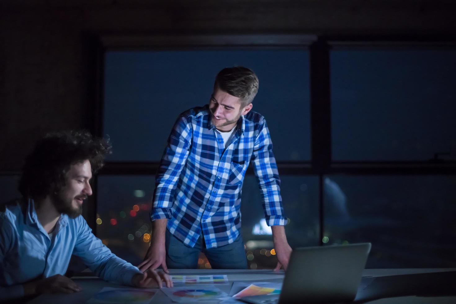 business people on construction site  in new startup office at night photo