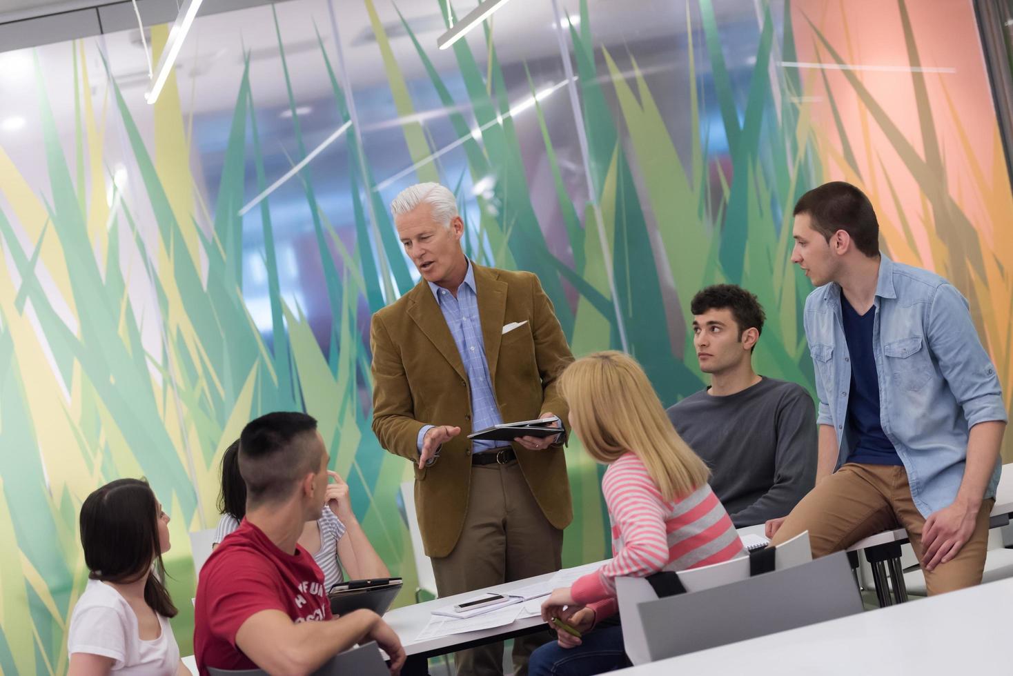 teacher with a group of students in classroom photo
