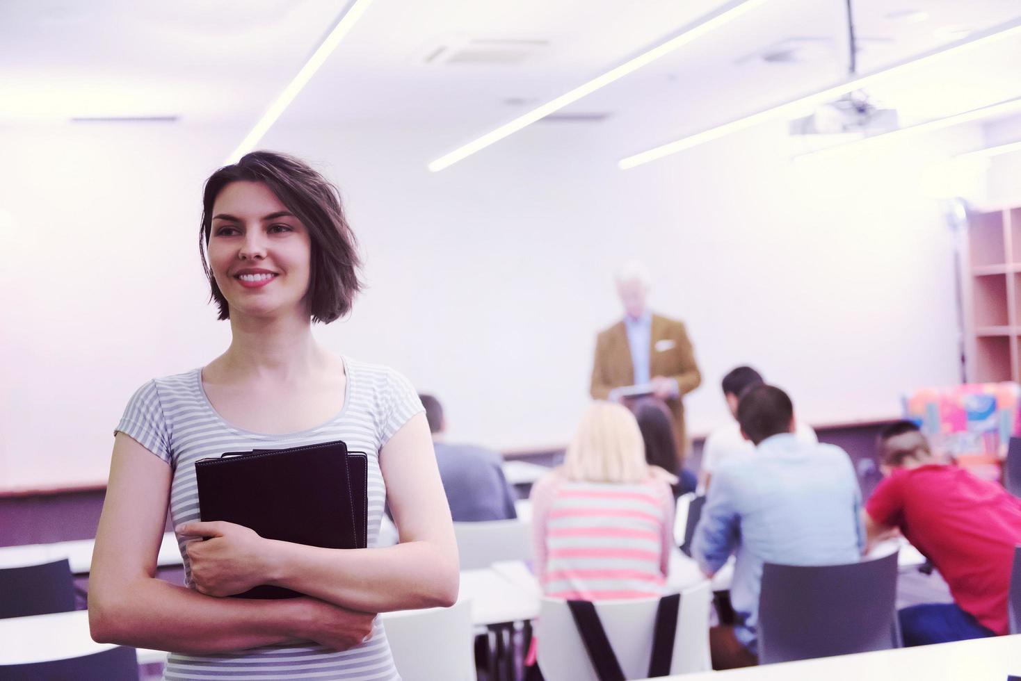 portrait of happy female student in classroom photo