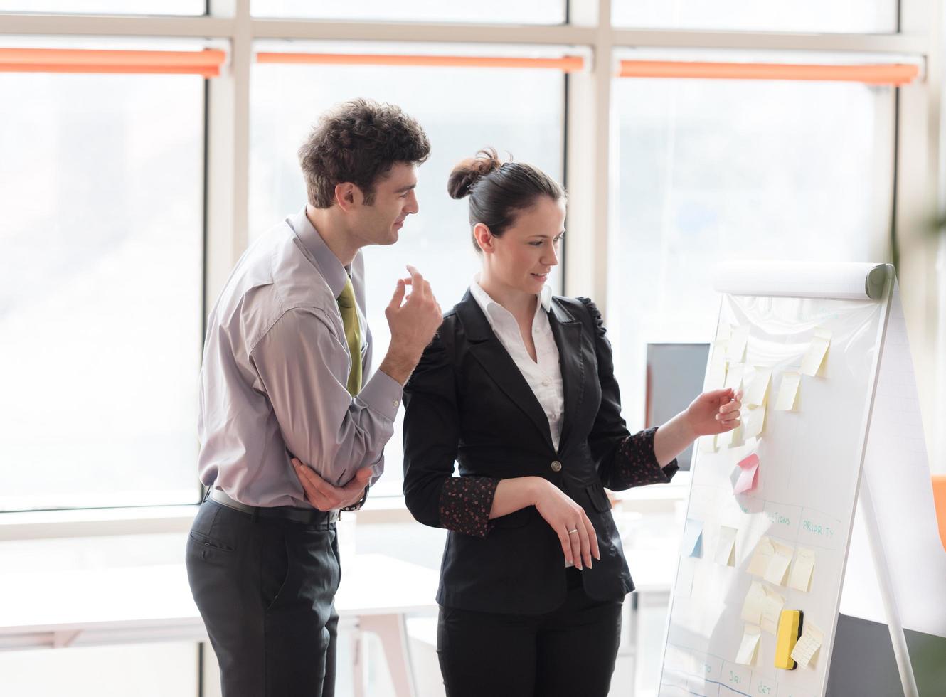 young couple working on flip board at office photo