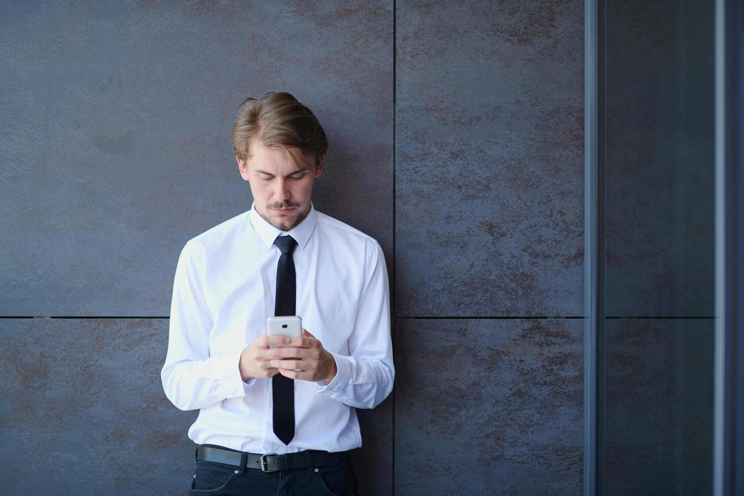 startup businessman in a white shirt with a tie using mobile phone photo