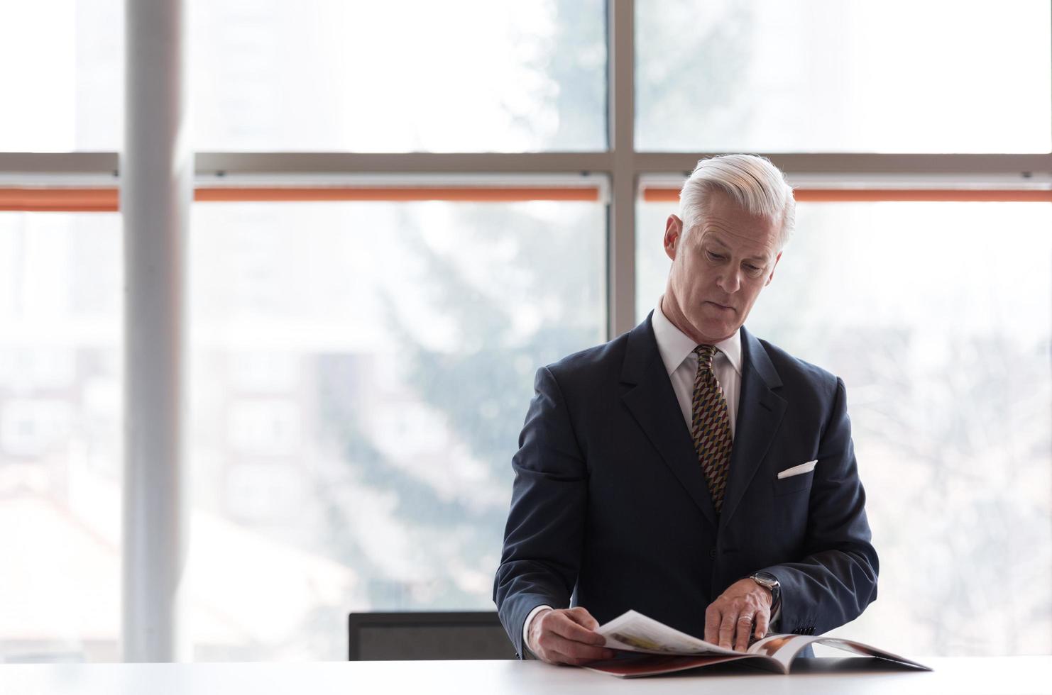 senior business man reading magazine photo