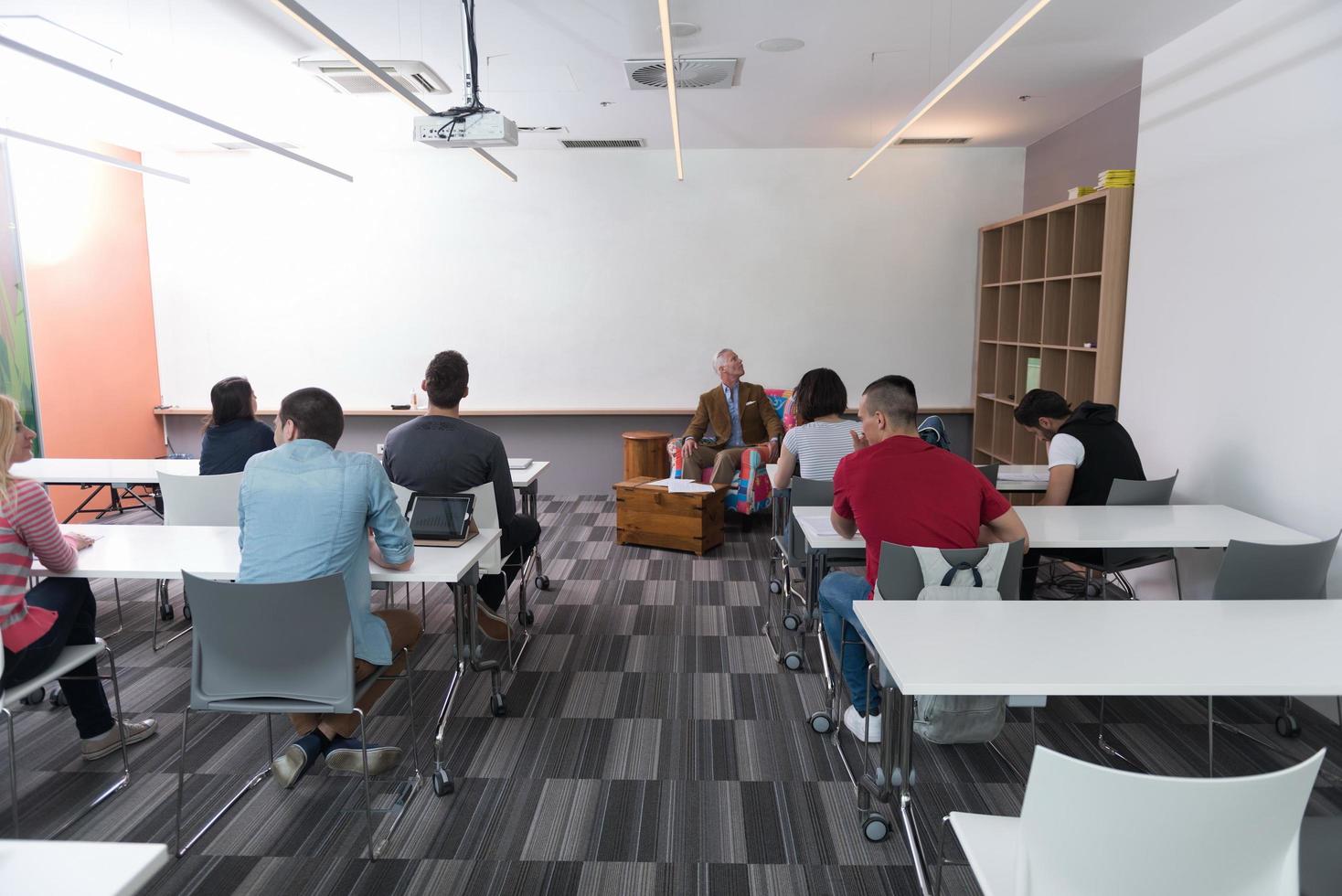 teacher with a group of students in classroom photo