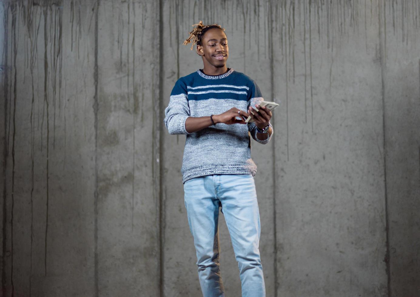 black business man displaying a spread of american dollar cash money photo