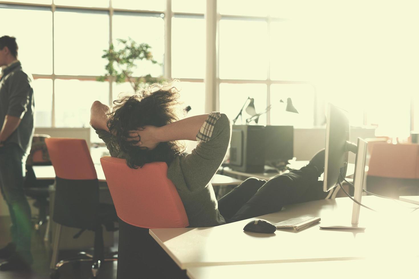 businessman sitting with legs on desk photo