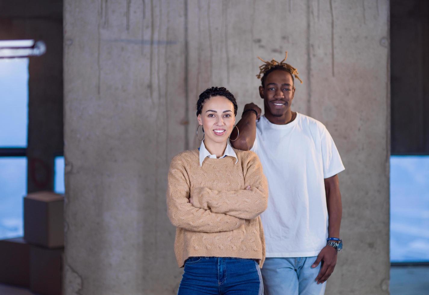 portrait of casual multiethnic business team in front of a concrete wall photo