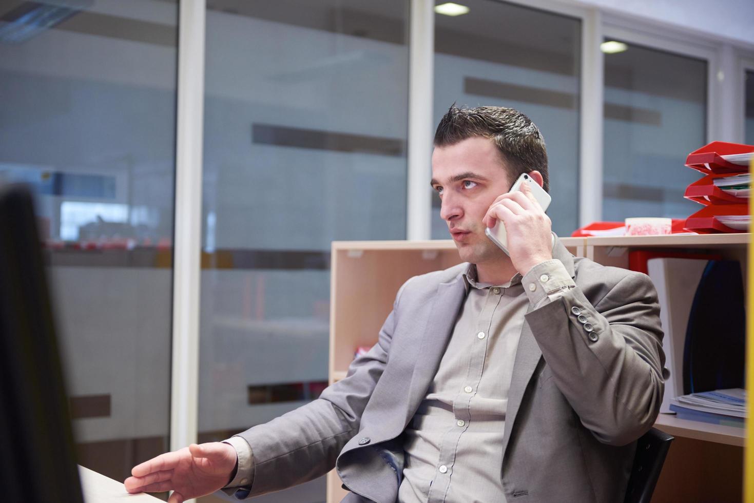 business man talking by phone in office photo