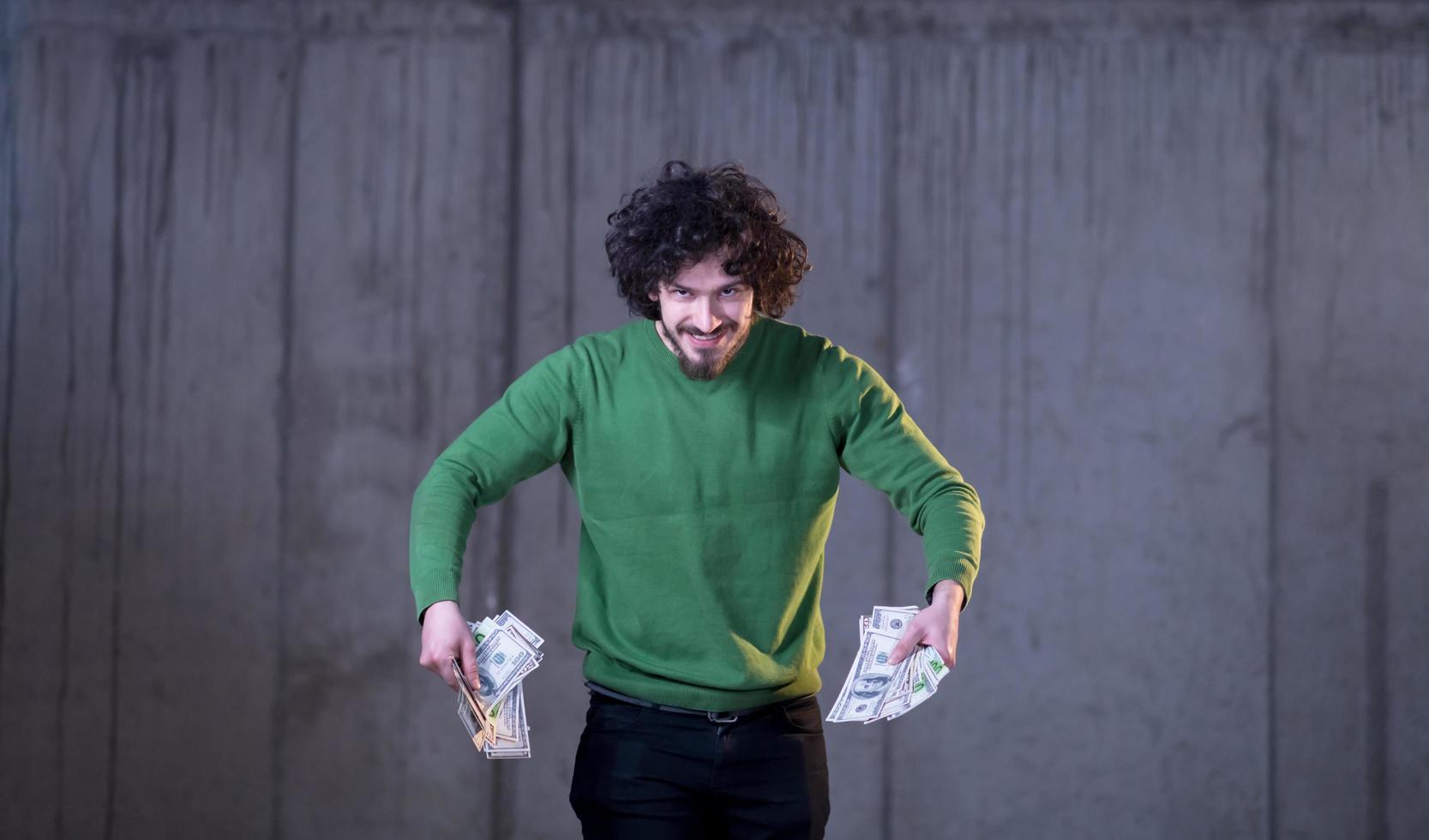 business man displaying a spread of american dollar cash money photo