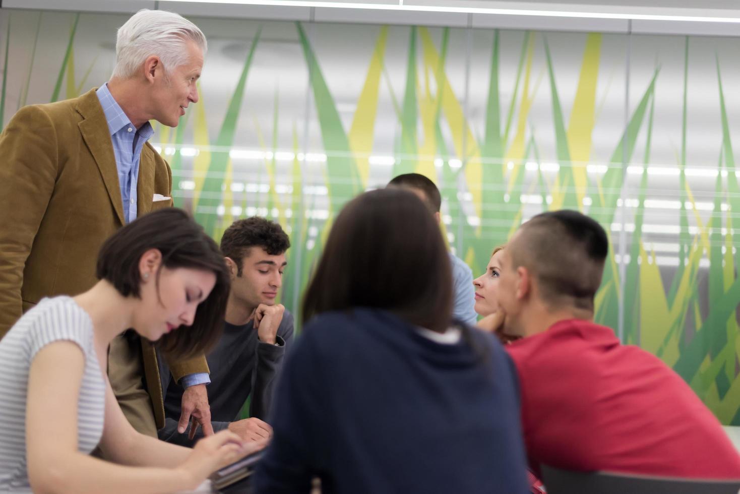 teacher with a group of students in classroom photo