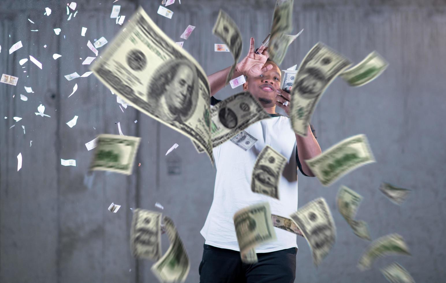 black businessman making the rain of money photo