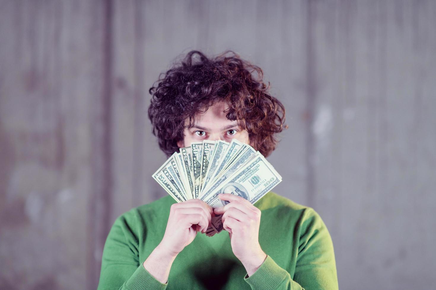 business man displaying a spread of american dollar cash money photo