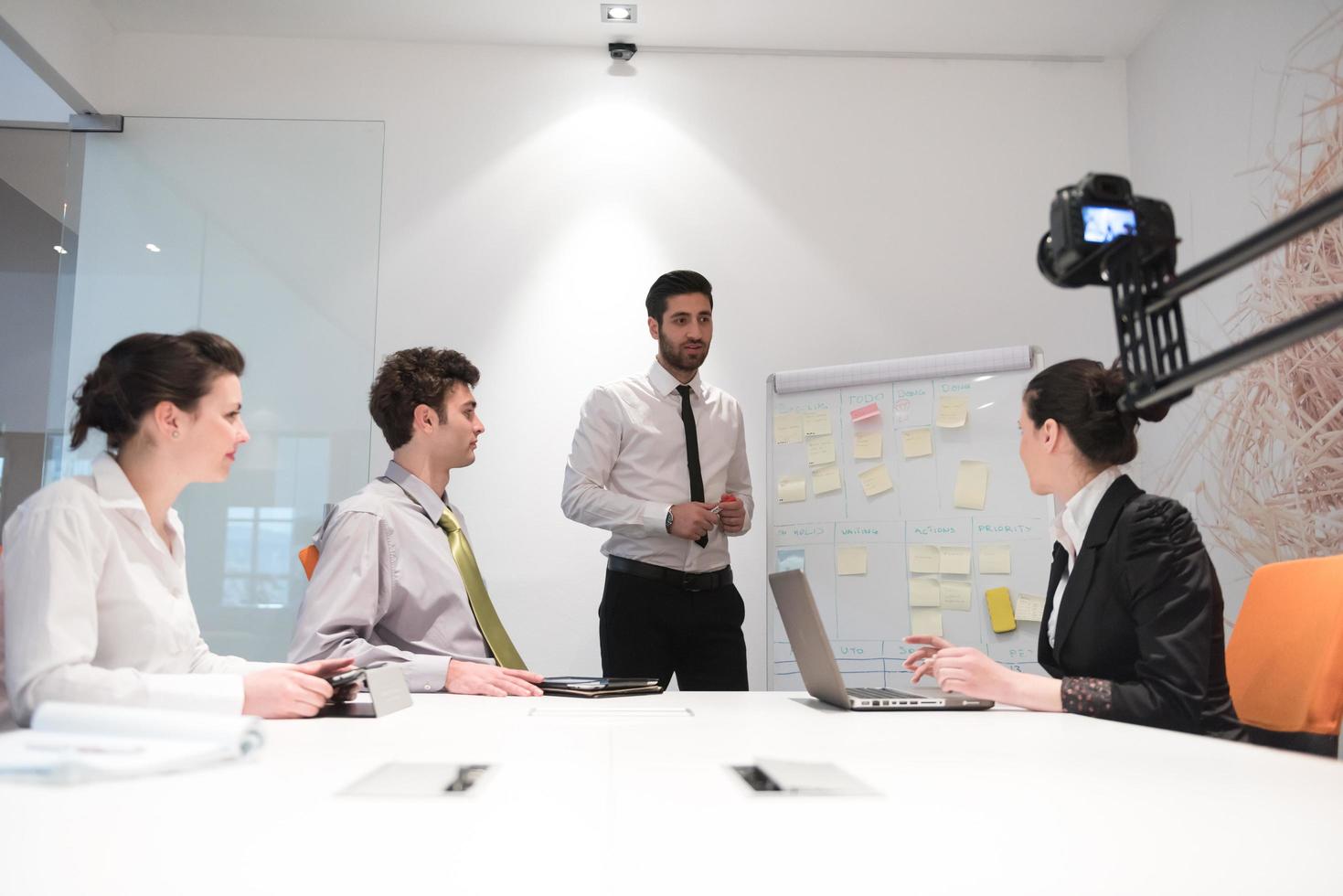 business people group brainstorming and taking notes to flip board photo