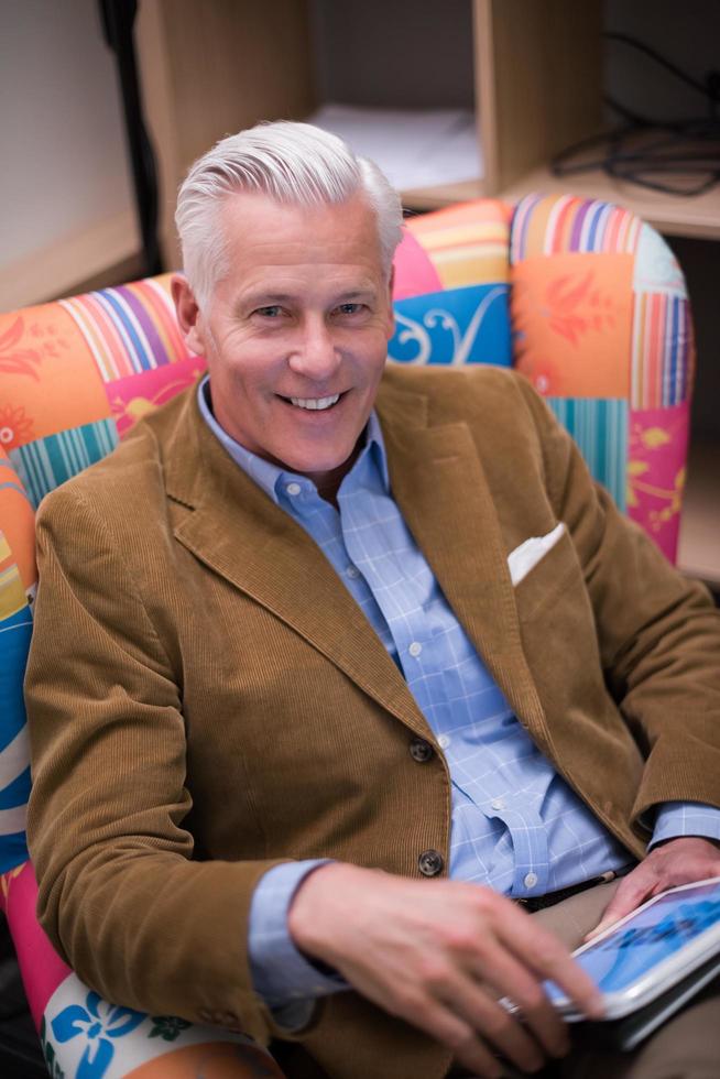 portrait of handsome teacher in colorful chair photo