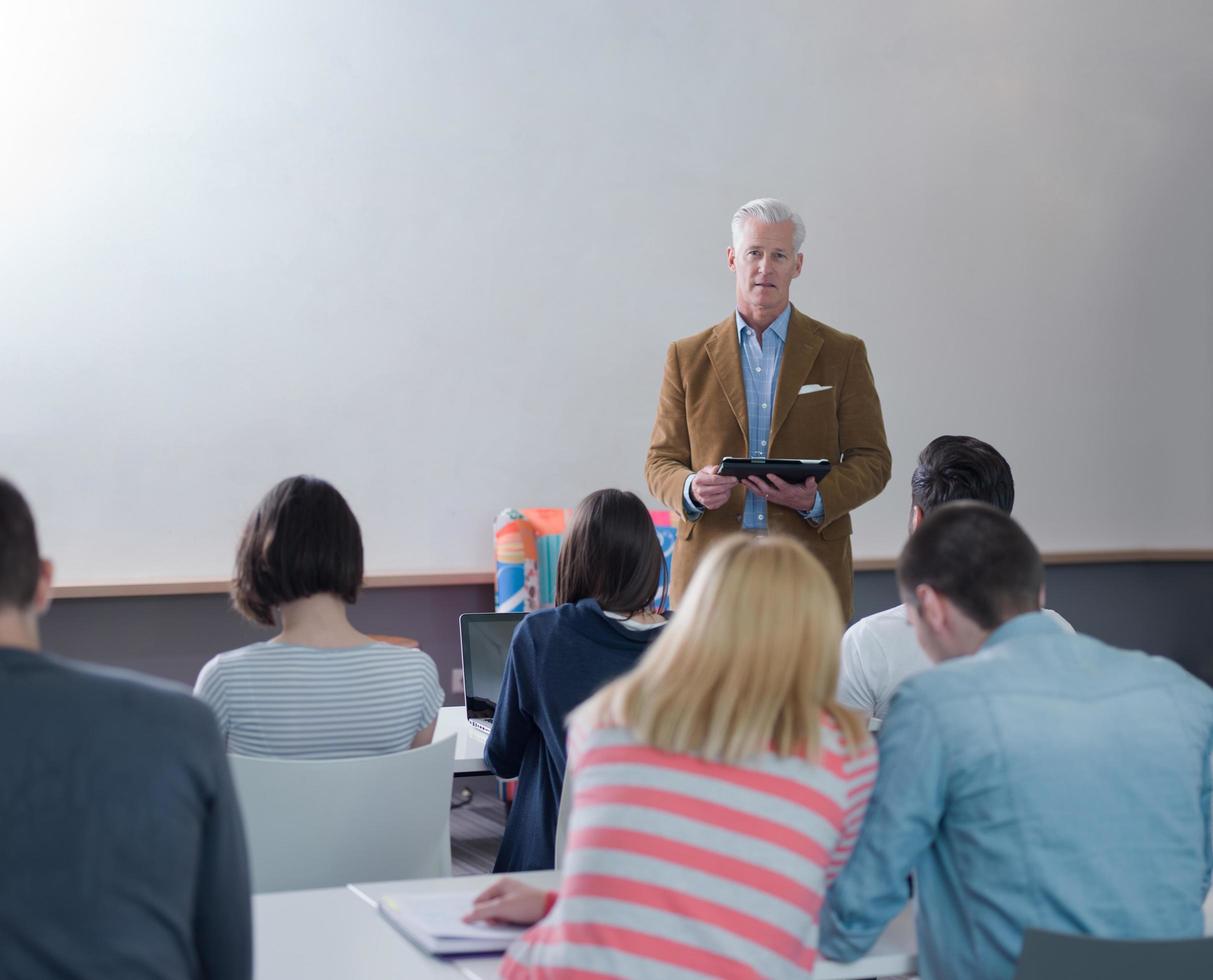 teacher with a group of students in classroom photo